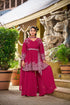 Model wearing deep pink peplum palazzo set with puffed full sleeves and V-neckline.