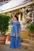 Side view showing flowy pleated palazzo pants with peplum kurti