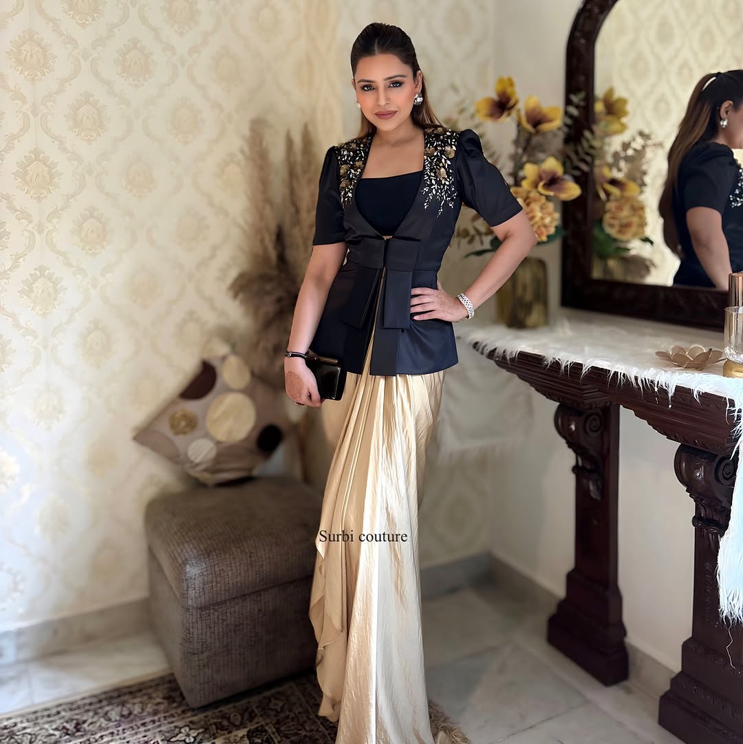 "Complete outfit of black blazer, golden dhoti skirt, and blouse made with premium fabrics."
