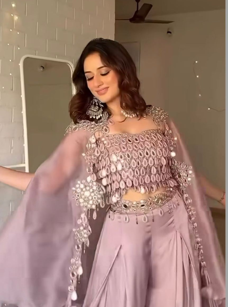 Mauve palazzo pants with flared silhouette and mirror work details for wedding celebrations.